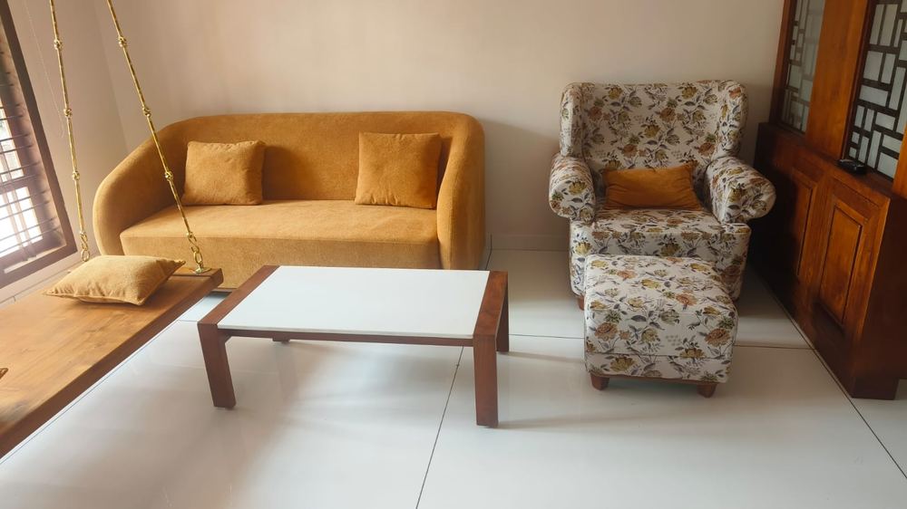 Mustard loveseat and floral wingback chair